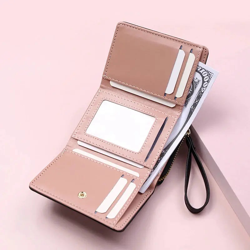 Women's pink PU tri-fold wallet with card slots, ID window, and wrist strap by Simples Market