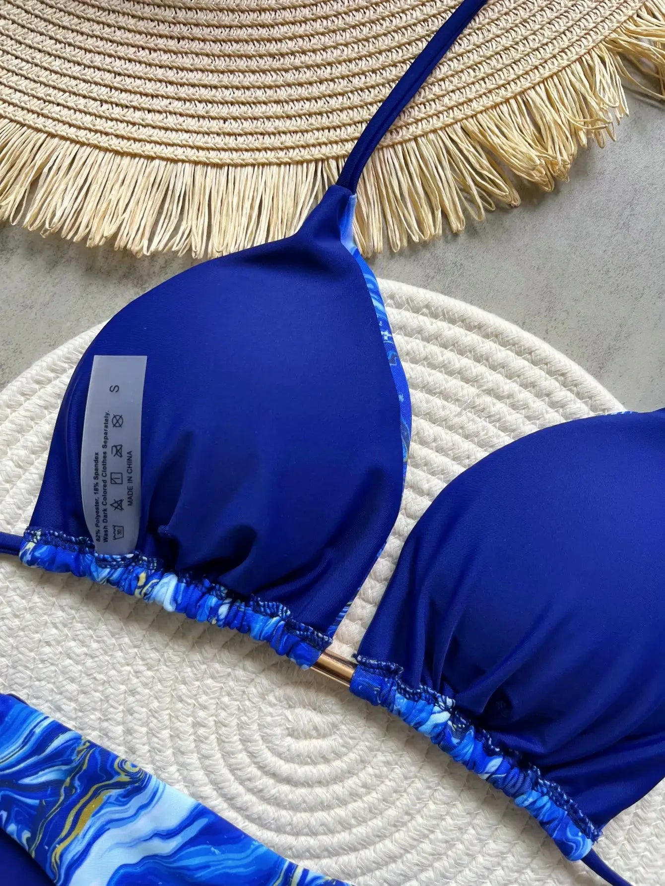 Two-piece blue halter bikini with a high-cut thong bottom, size S.