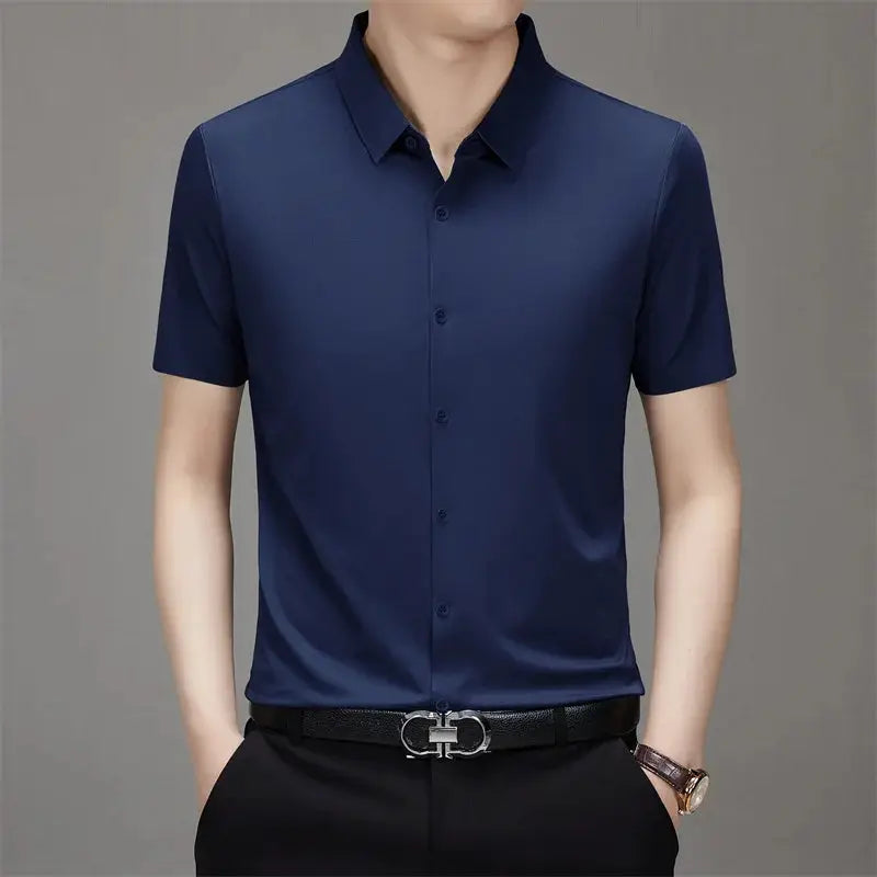 Men's navy blue solid short-sleeve button-down shirt, worn with black belt and trousers.