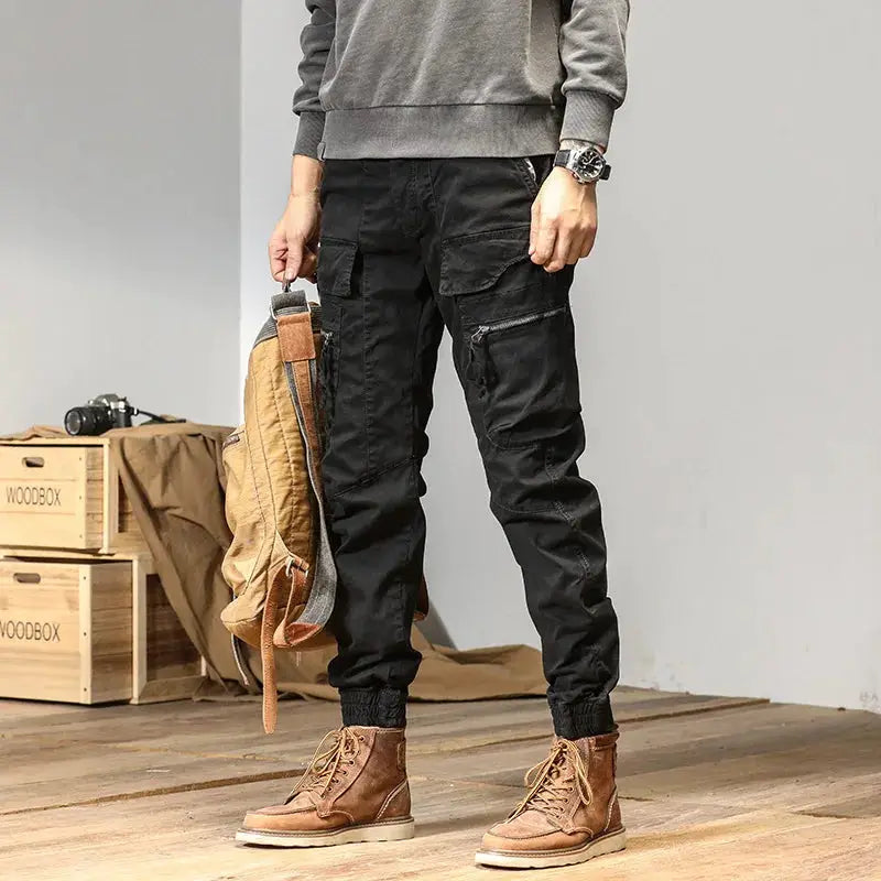 CAAYU men's cargo joggers in black with multi-pocket design, zip pocket and ribbed ankle cuffs style