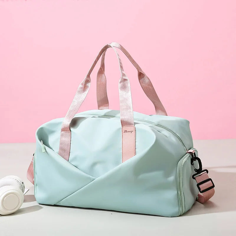 Fitness travel bag in pastel blue with pink handles and detachable pink shoulder strap