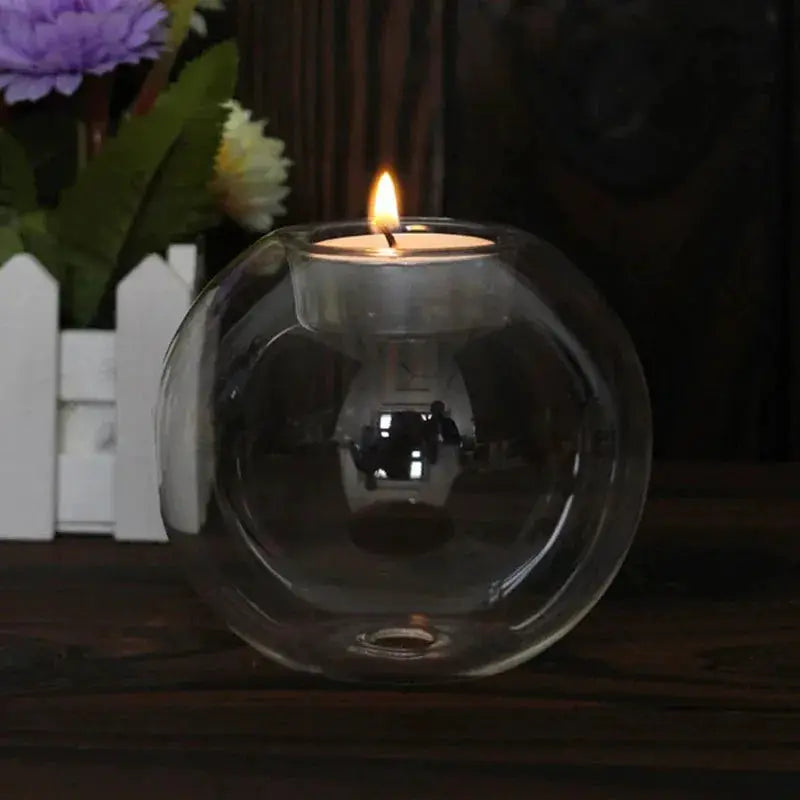 Elegant round clear glass candle holder with a lit tealight