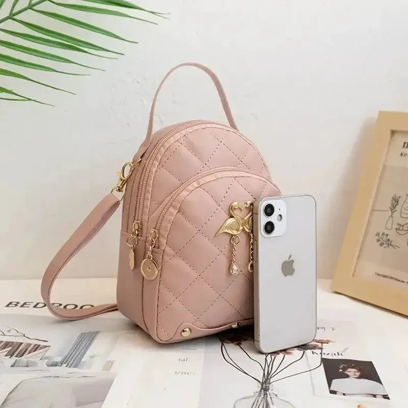 Simples Market pink quilted mini backpack with top handle and gold hardware