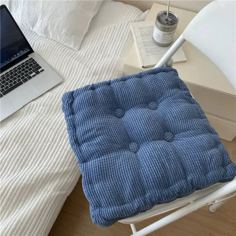 Blue square cushion with corduroy texture and tufted panels, thick knee pillow for home or office