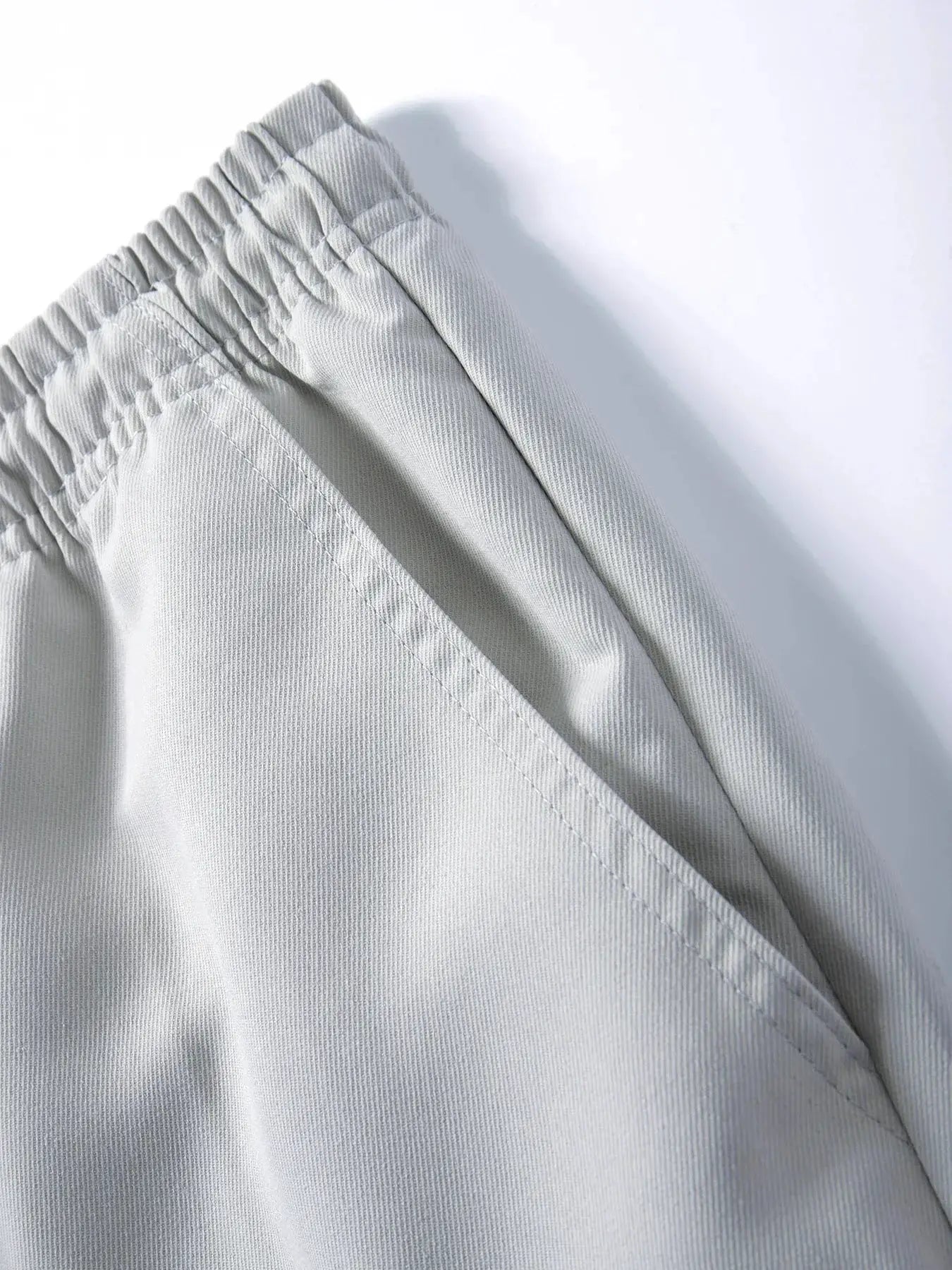 Men's casual cargo sweatpants in light gray with elastic waist, drawstring, and pockets