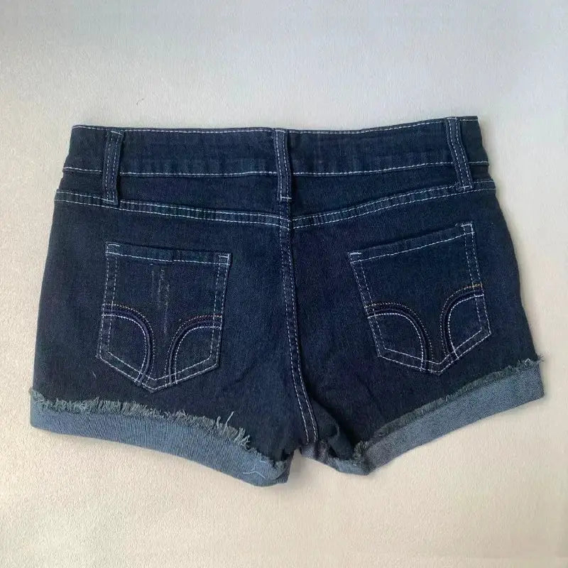 Women's dark blue denim shorts with frayed rolled hems and back pockets.