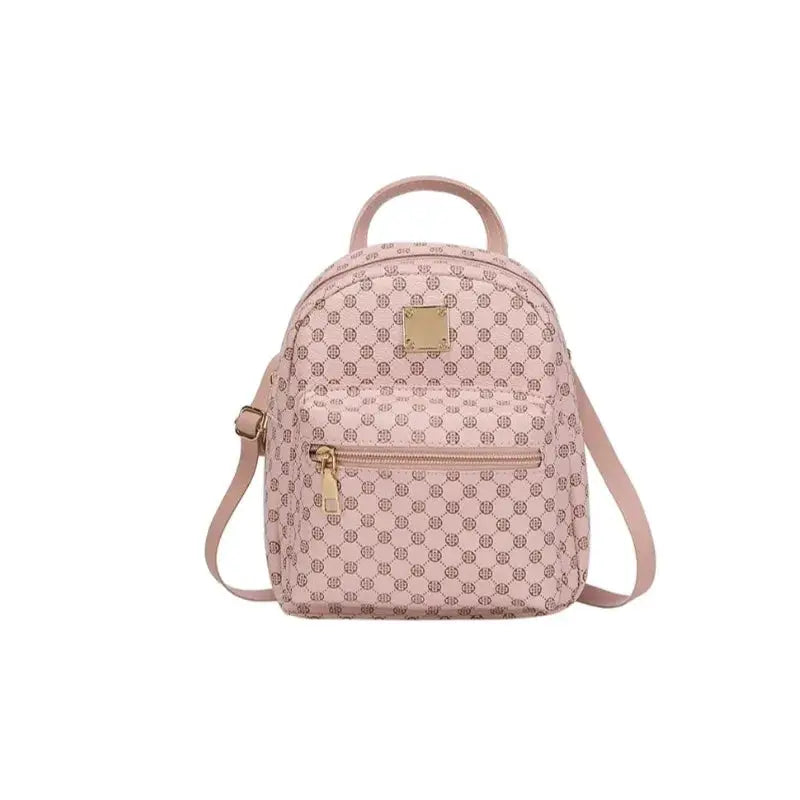 Simples Market pink mini women’s backpack with monogram pattern, gold hardware, top handle, and adjustable strap.