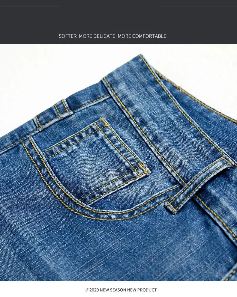 Men's slim denim shorts in blue with yellow stitching; close-up of back pocket detail.