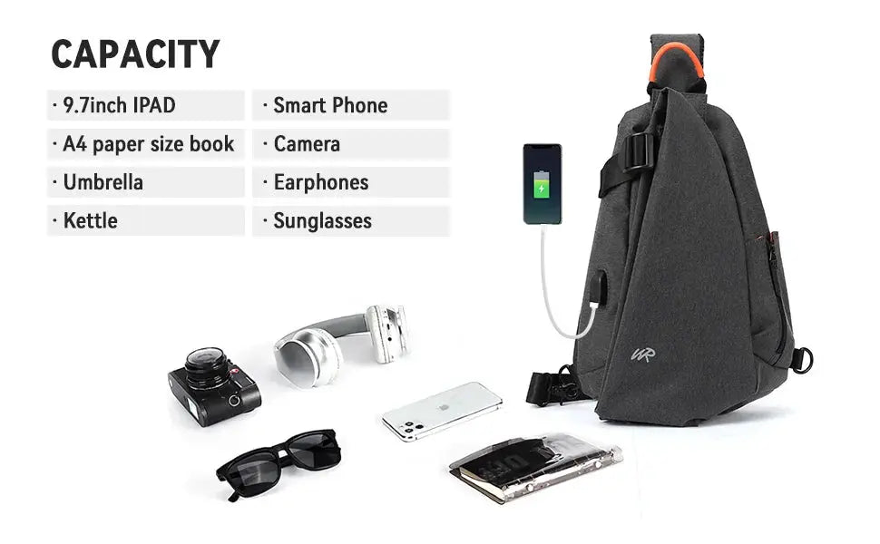 Anti-Theft crossbody sling bag in charcoal gray with USB port; shown with phone, camera, headphones, and sunglasses.
