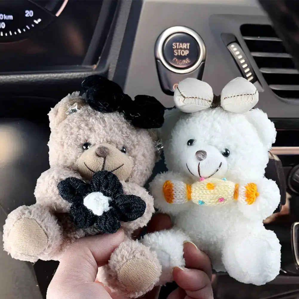 Pilot Bear plush car ornament pair; beige bear with black flower, white bear with yellow scarf