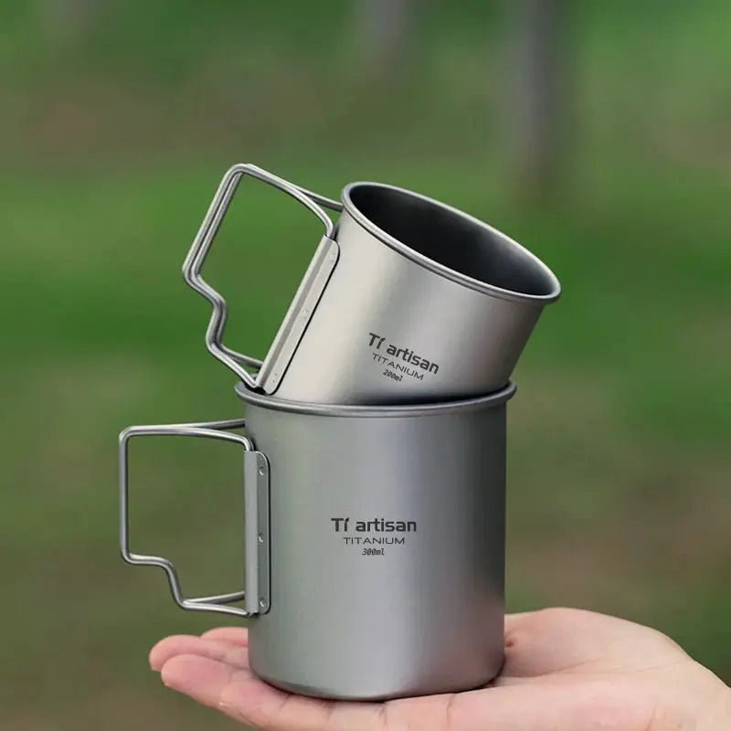 Tiartisan titanium cup set by Simples Market with folding handles; two-piece camping mugs