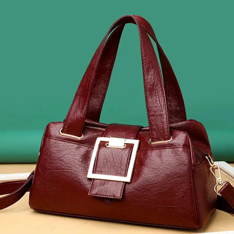 Women leather top-handle bag in burgundy with a gold-tone square buckle, large-capacity design