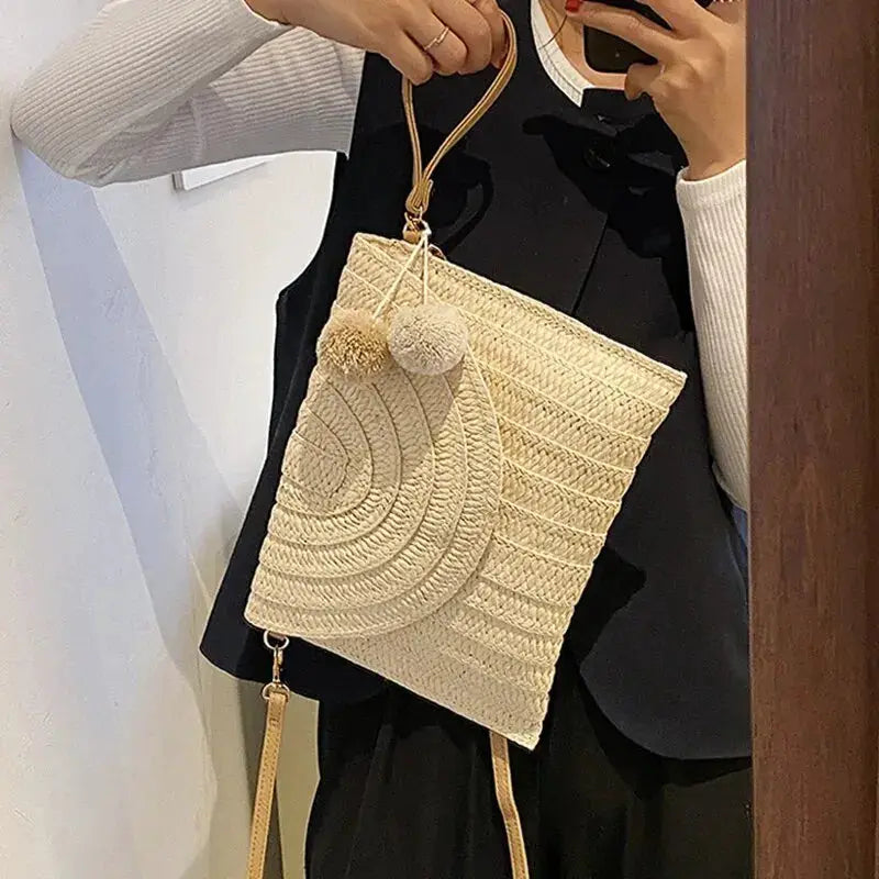 Simples Market handmade straw beach shoulder crossbody bag; natural woven envelope clutch with pompom accents