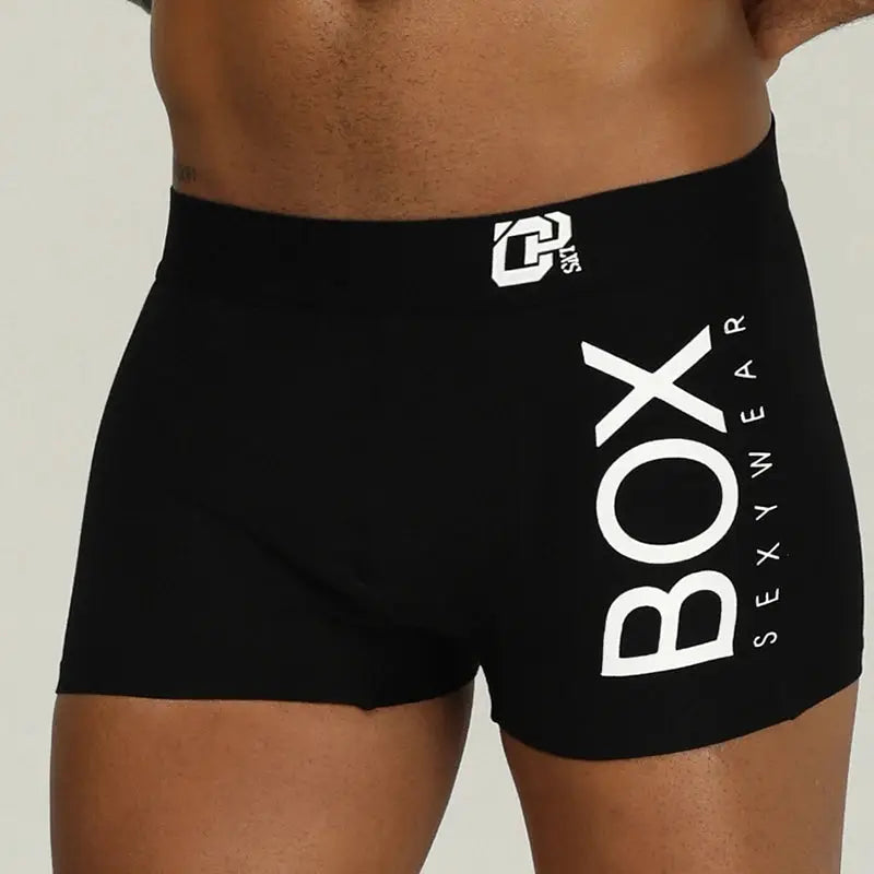 Men's black cotton boxer briefs by Simples Market with bold white BOX branding along the leg