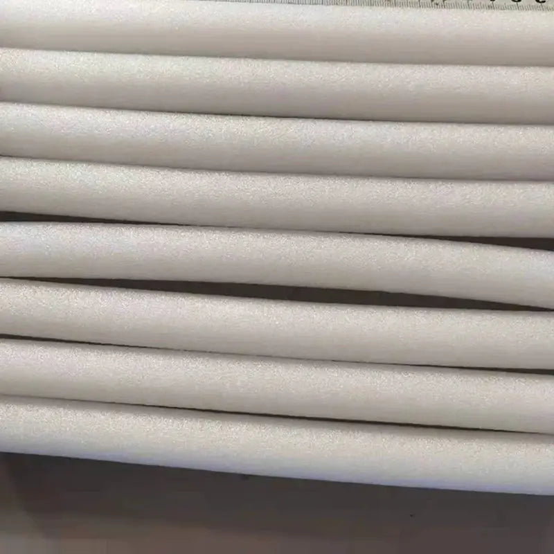 White foam sticks, 8 pcs, 20–25 cm each, stacked, for stretch sofa cover.