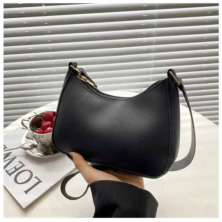 Black solid-color handbag, small square crossbody with gold-tone hardware and single shoulder strap