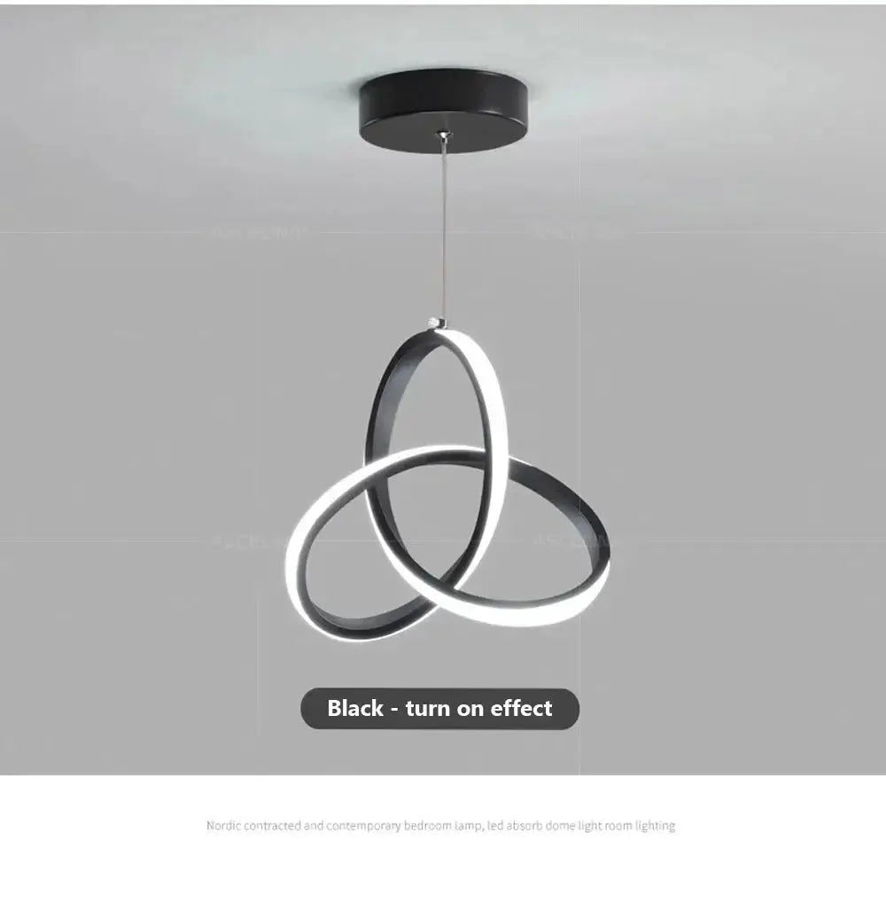 Nordic LED ceiling pendant lamp in black with interlocking circular rings for modern dining or living spaces.
