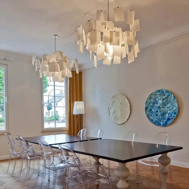 Ingo Maurer style paper chandelier LED E27 replica by Simples Market over a dark wood dining table with clear chairs.