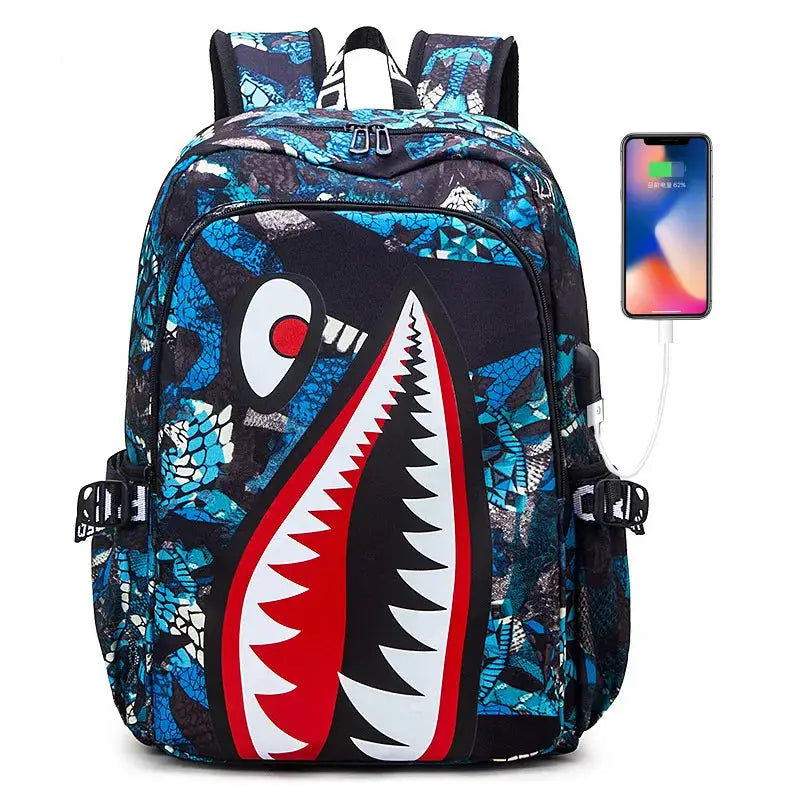 Shark-print kids backpack by Simples Market with blue/black geometric pattern and large shark mouth graphic