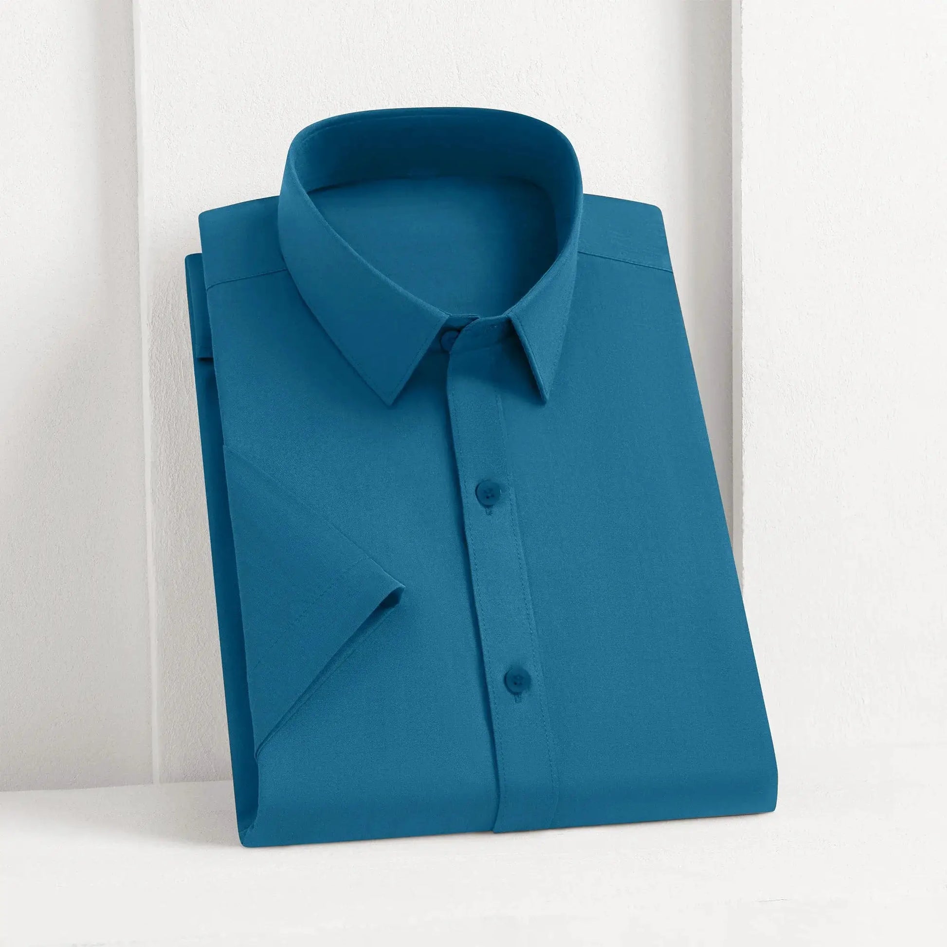 Men's blue solid dress shirt folded with collar and front buttons.