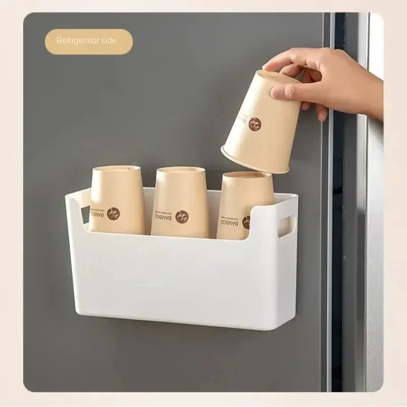 White cabinet door organizer rack holding four beige cups inside a kitchen cabinet.