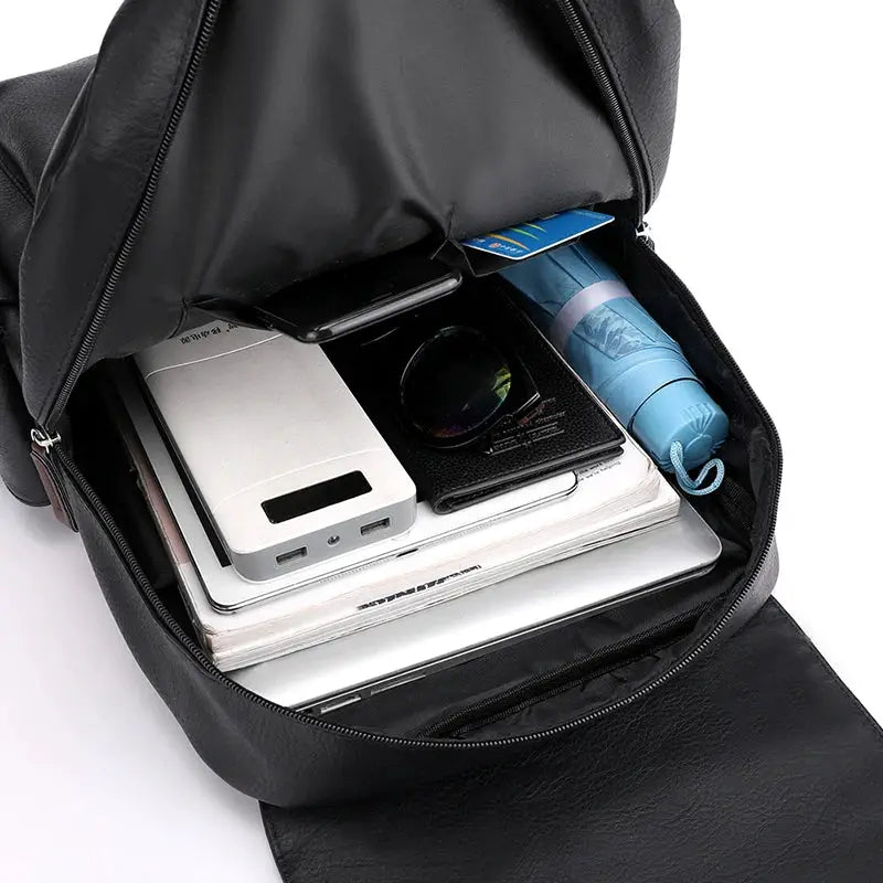 Black PU leather backpack with large laptop compartment; interior holds 4 items laptop, power bank, phone and notebook.