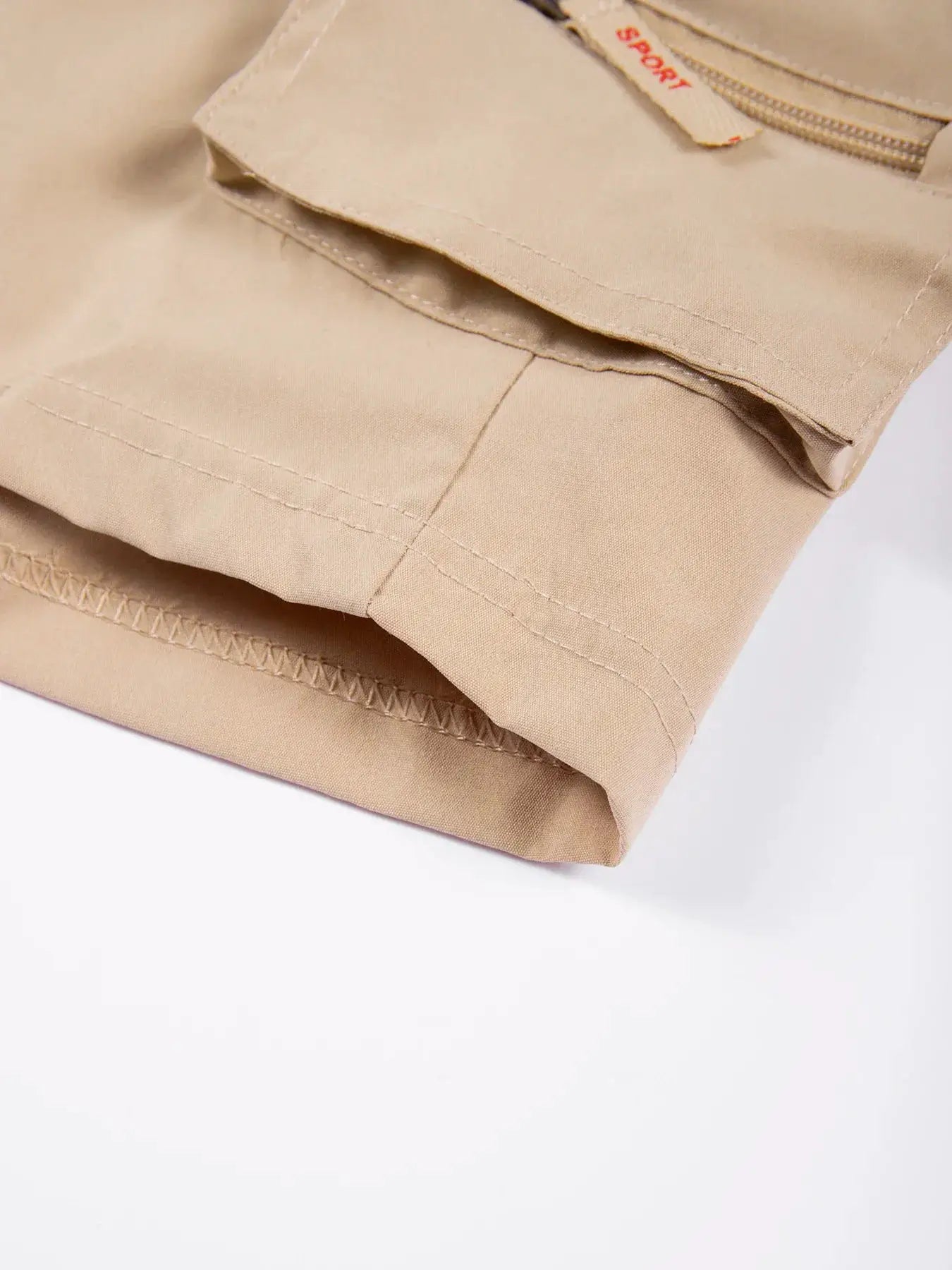 Beige men's cargo shorts with multiple pockets for casual outdoor wear.