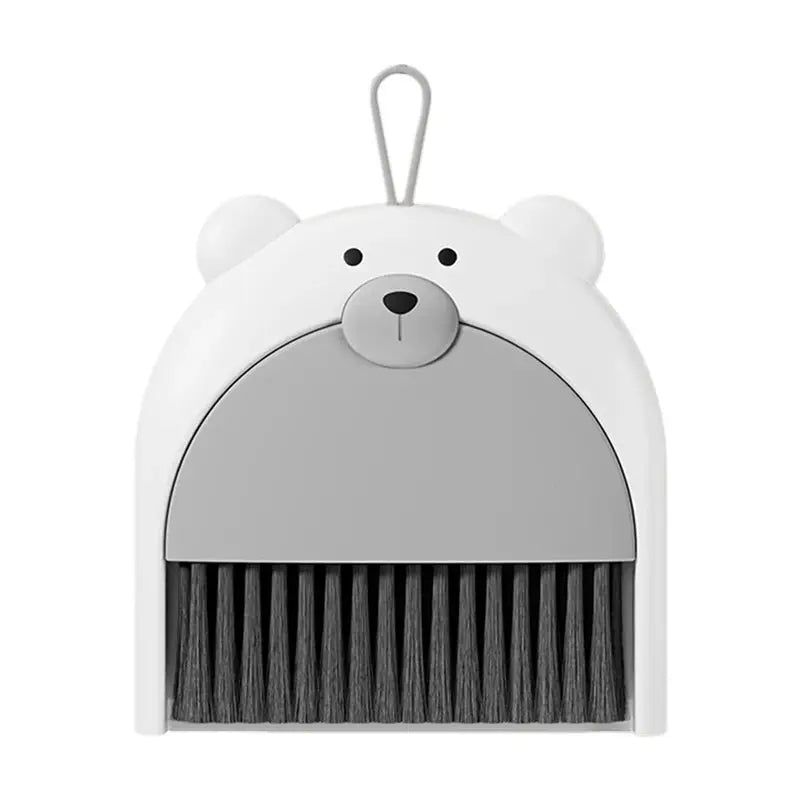 Bear-shaped small broom and dustpan set by Simples Market; white bear head, gray dustpan, black bristles.