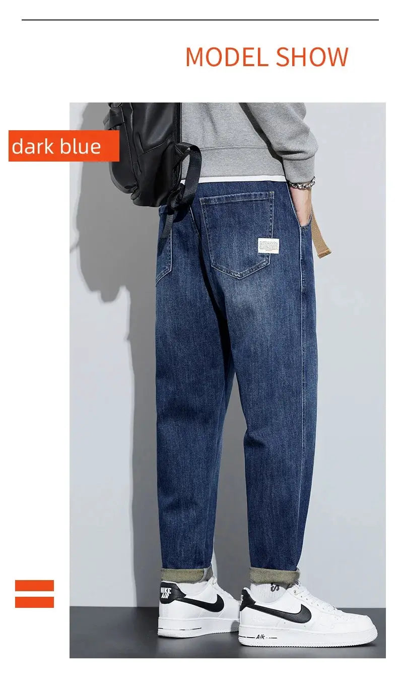 Men's winter dark blue fleece jeans, loose straight fit with rolled cuffs, paired with white Nike sneakers