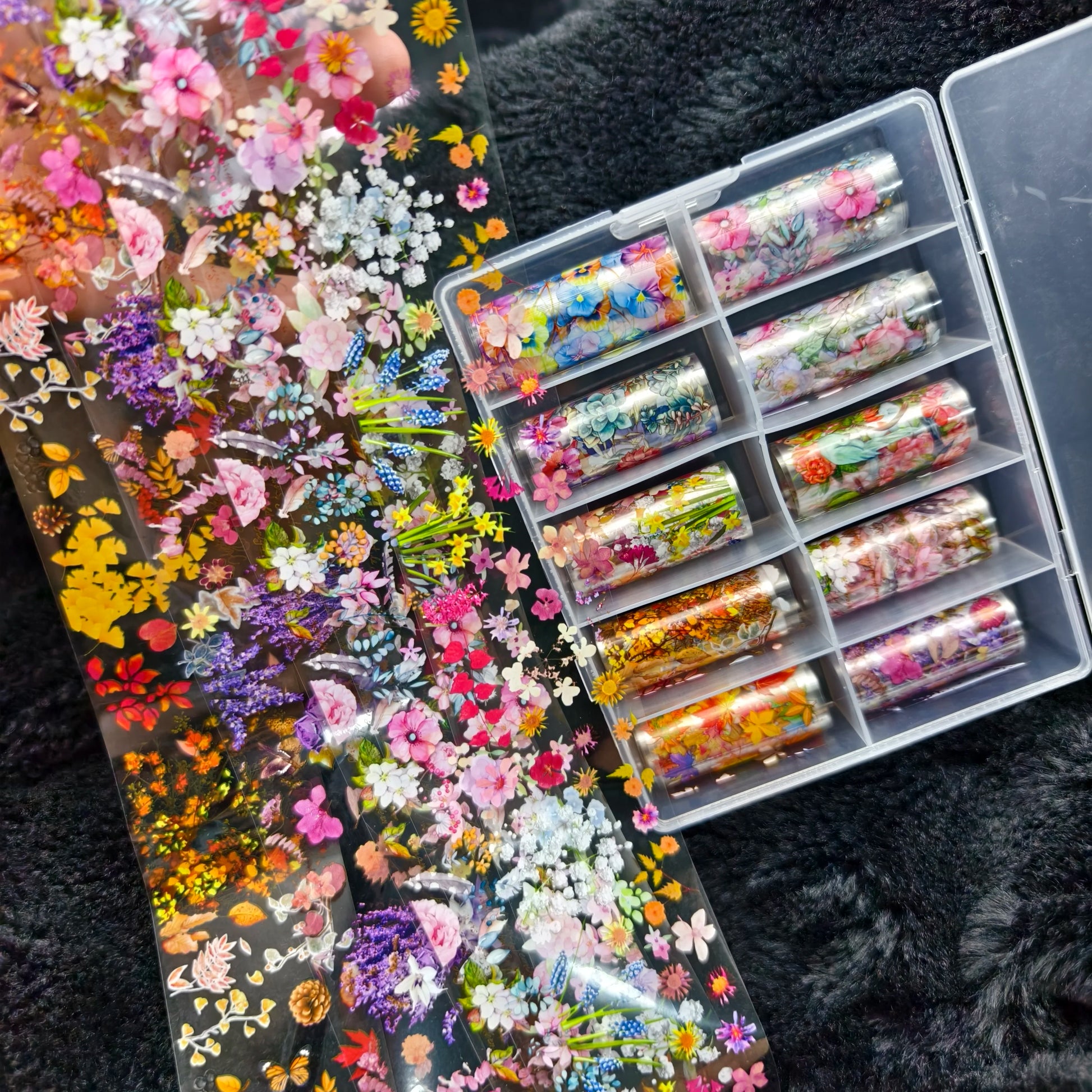 Nail foil set by Simples Market; 10 rolls of floral, bow and marble designs in clear case