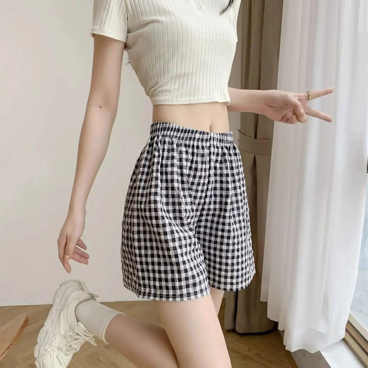 Summer Home Shorts for women; high-waisted, black and white plaid casual pajama shorts with elastic waistband.