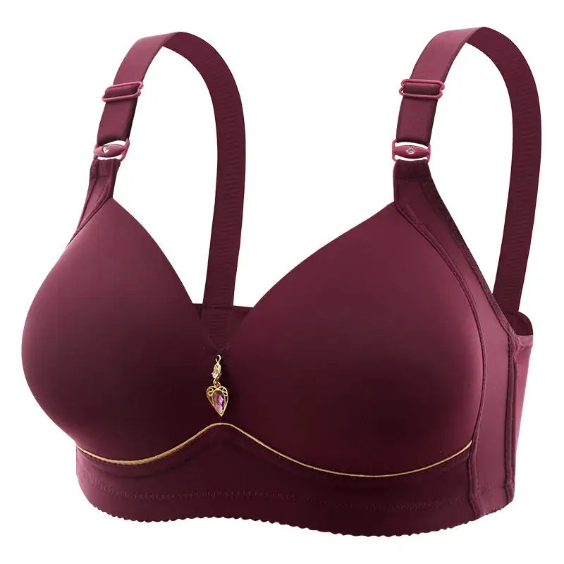 Maroon glossy molded-cup bra with wide straps, gold trim, and a pendant between cups