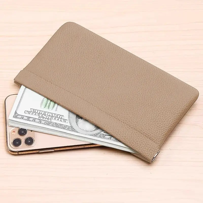 Tan faux leather long wallet with cash and a smartphone peeking out