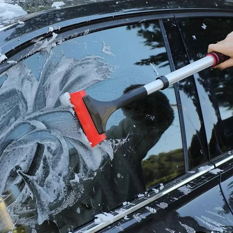 Extendable aluminum snow brush ice scraper with red head for car windshield, extra-long design.