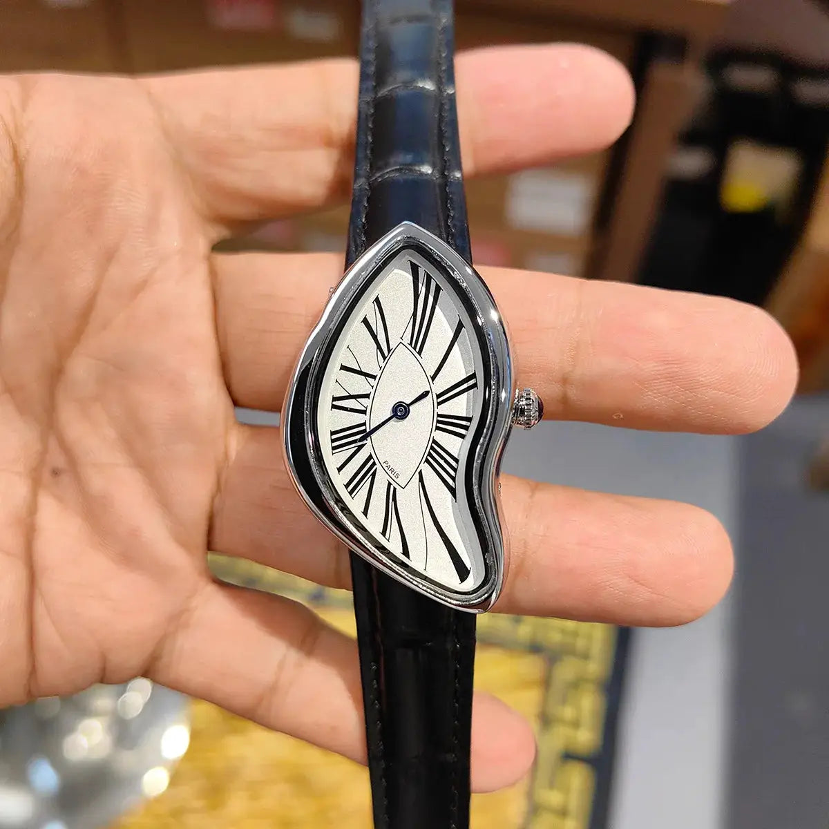 New Alien Crash Melt Twist Y2K wristwatch with black leather strap and warped silver case.