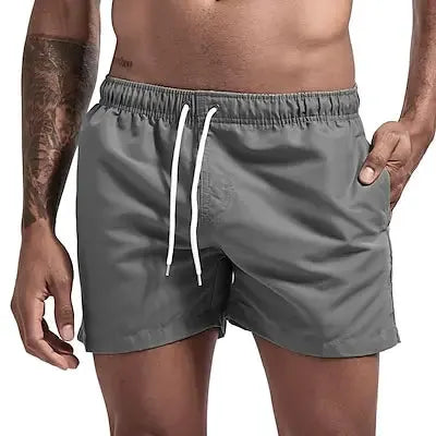 Simples Market men's grey quick-dry board shorts with white drawstring and pockets.