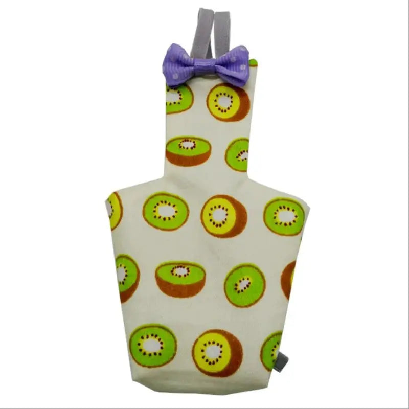 Simples Market parrot diaper with bowtie flight suit; white fabric with colorful kiwi slices and a purple bow