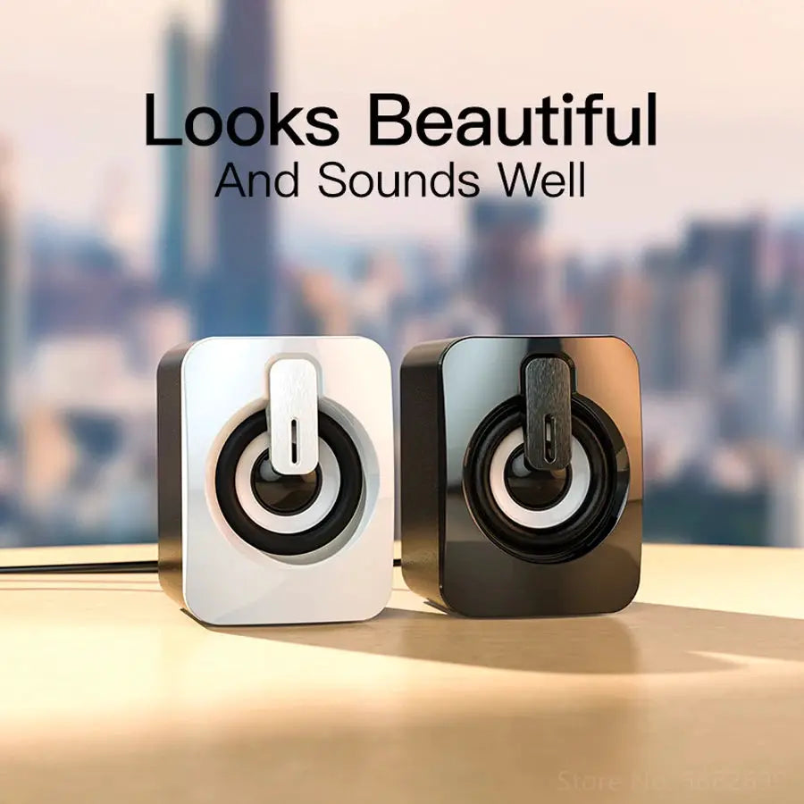 Pair of computer speakers in white and black with circular drivers