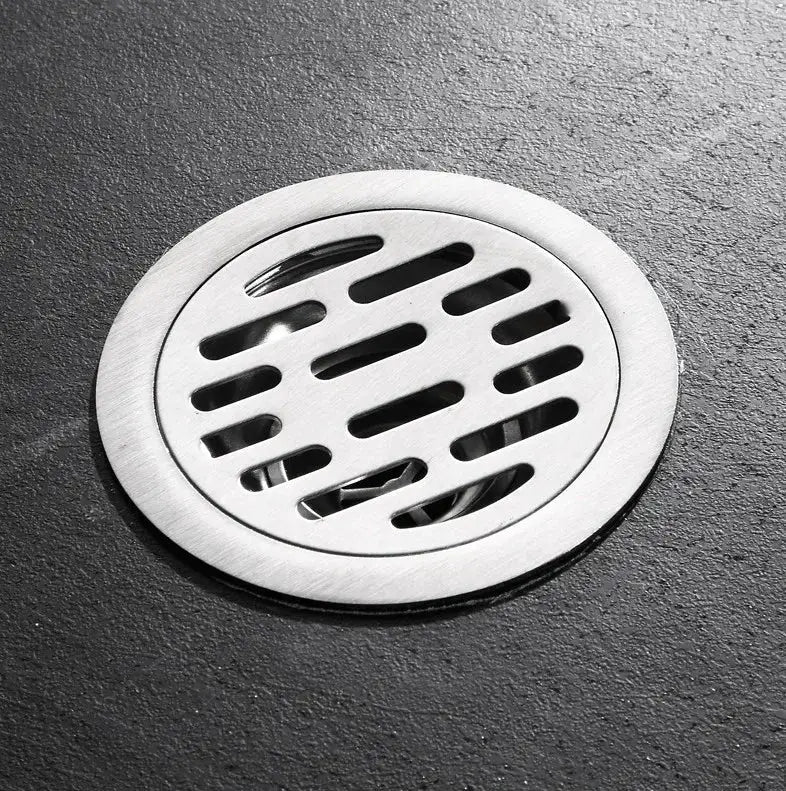 Stainless steel floor drain with round slotted grate for bathroom or kitchen use