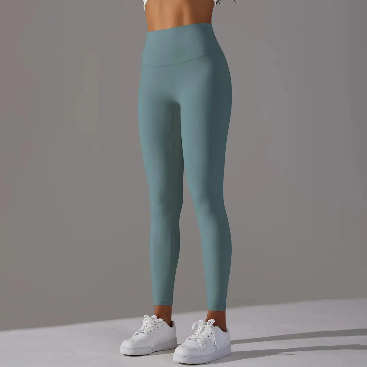 High waist naked-feeling leggings in teal-green on a model; versatile fitness and yoga pants.