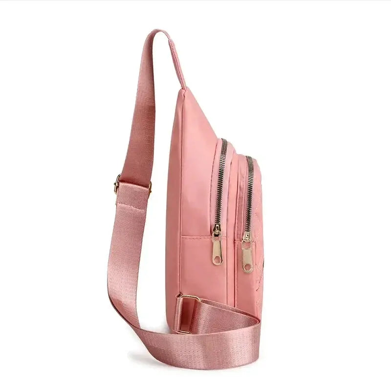 Pink crossbody shoulder bag with adjustable strap and dual zip pockets