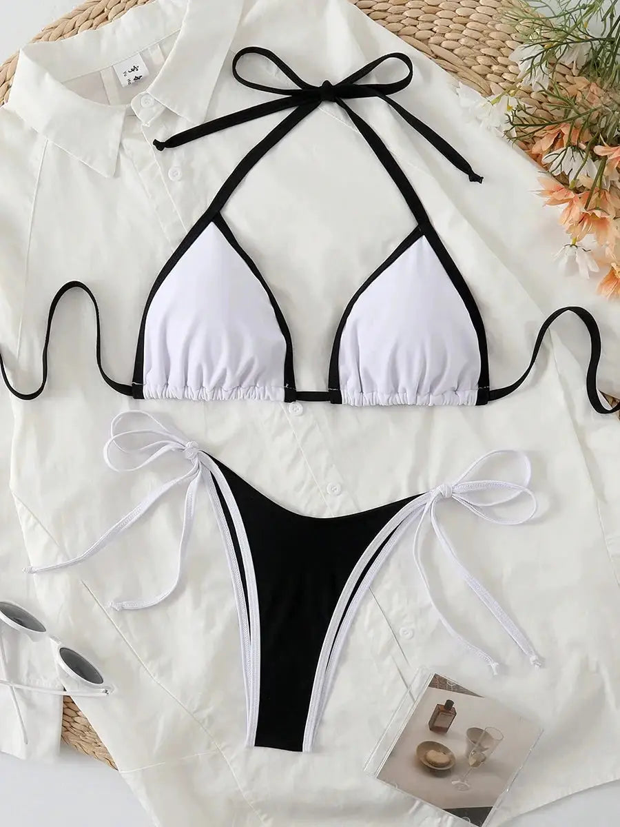 Sexy two-piece micro bikini: white triangle top with black trim, black thong bottom with white side ties