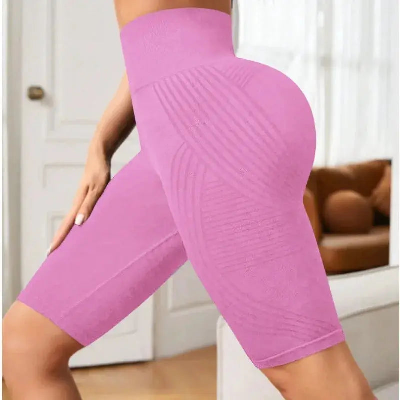 Pink high-waisted seamless knit yoga shorts for women, mid-thigh length, stretchy hip-lift design