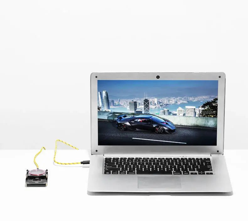 Proxmark3 RFID card reader/writer kit connected to a silver laptop on a white desk