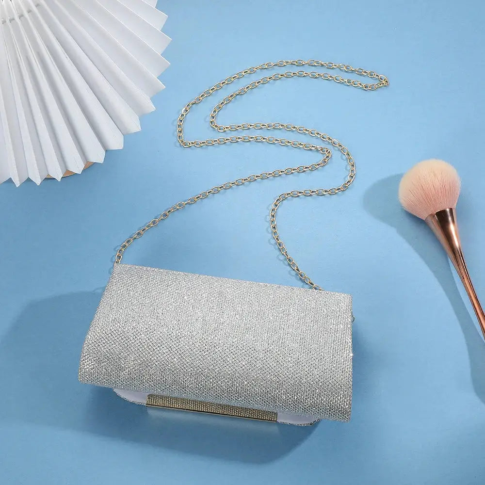 Silver sequined clutch bag from Simples Market with chain strap