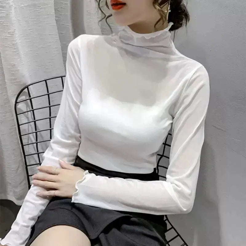 White women's long-sleeve mock-neck top with ruffled collar and fitted silhouette