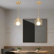 Pendant lights: two gold iron cage LED pendants over a dining table.