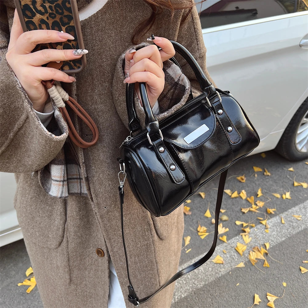Mini top-handle bag by Simples Market in black patent PU leather with shoulder strap