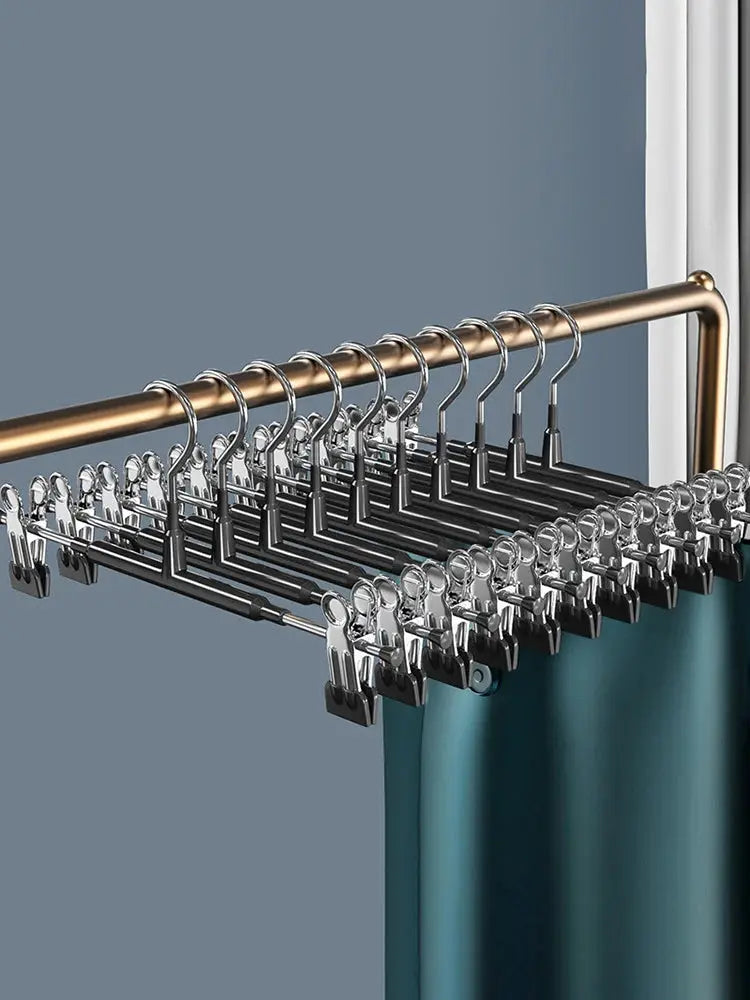 Wardrobe drying rack with stainless steel clip hangers on a rod for pants and skirts