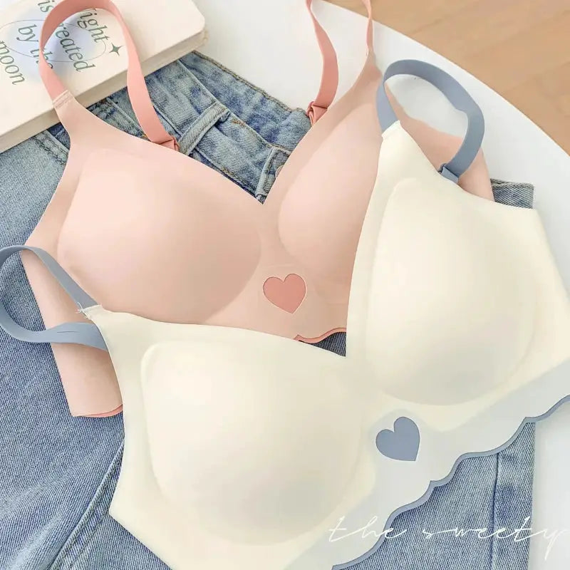 Two-pack push-up bras with heart patterns; pink and white with pink and blue straps, seamless wireless lingerie